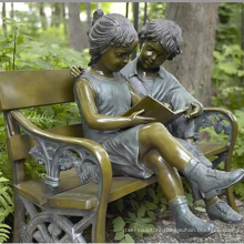 bronze boy and girl sitting on bench sculpture